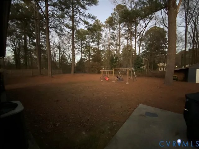 a view of outdoor space with garden and trees