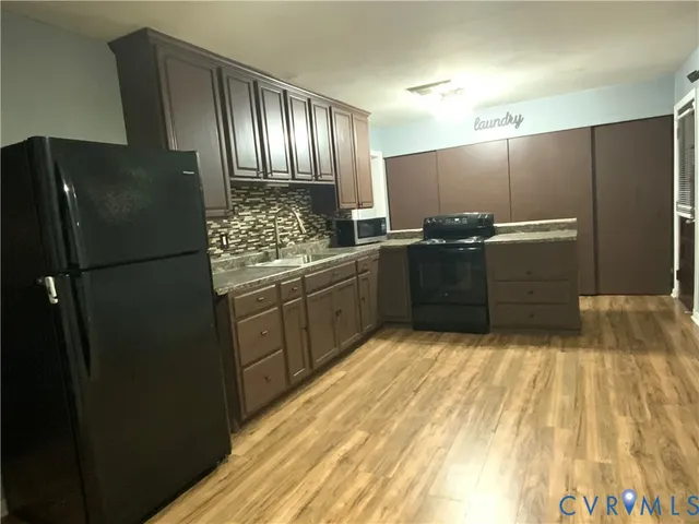 a kitchen with stainless steel appliances granite countertop a refrigerator and a sink