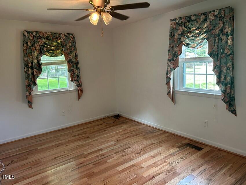 111 Colonial Drive Clinton, NC 28328 - Photo 11 of 21 wooden floor in an empty room with a window