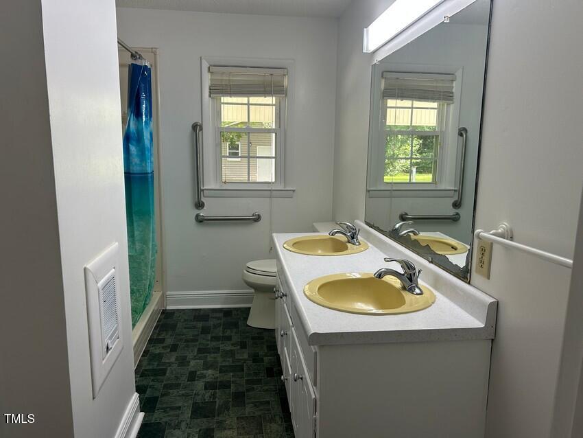 111 Colonial Drive Clinton, NC 28328 - Photo 14 of 21 a bathroom with a sink and a mirror