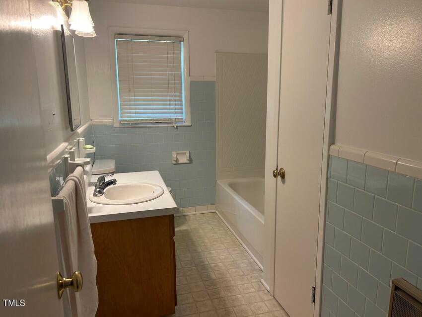 111 Colonial Drive Clinton, NC 28328 - Photo 15 of 21 a bathroom with a sink and mirror with bathtub