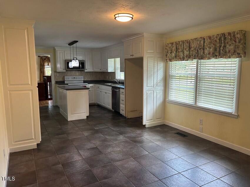 111 Colonial Drive Clinton, NC 28328 - Photo 8 of 21 a kitchen with a refrigerator and white cabinets