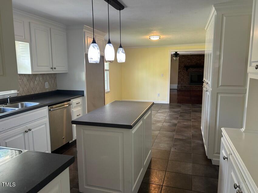 111 Colonial Drive Clinton, NC 28328 - Photo 9 of 21 a kitchen with a sink and chandelier