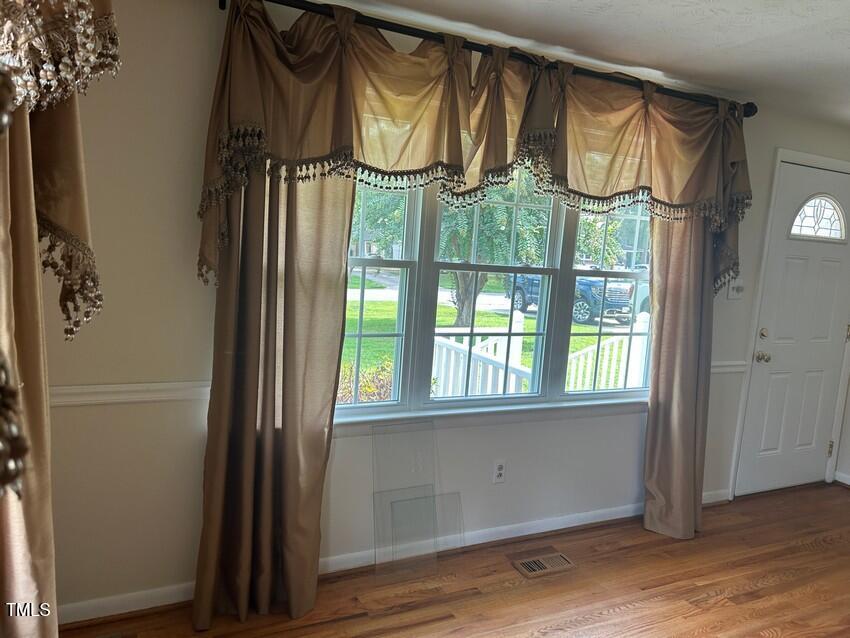 111 Colonial Drive Clinton, NC 28328 - Photo 10 of 21 an empty room with wooden floor and a window
