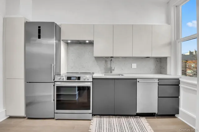 a kitchen with stainless steel appliances granite countertop a stove and a refrigerator