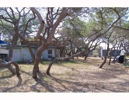 a backyard of a house with barbeque oven table and chairs