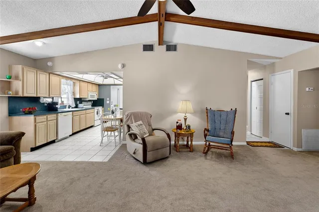 a kitchen with stainless steel appliances granite countertop a sink a stove and cabinets