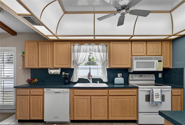 a kitchen with stainless steel appliances granite countertop a sink and cabinets