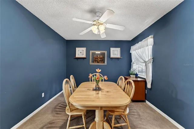 a dining room with furniture and chandelier