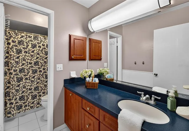 a bedroom with two beds and a potted plant