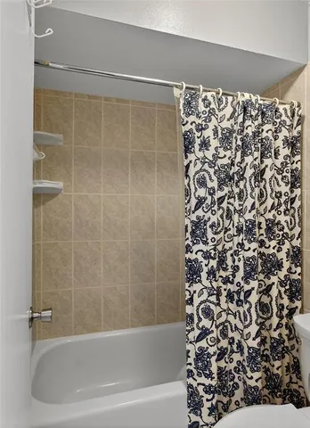 a bedroom with a bed and a potted plant