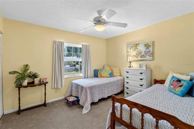 a bedroom with a bed chandelier and a window