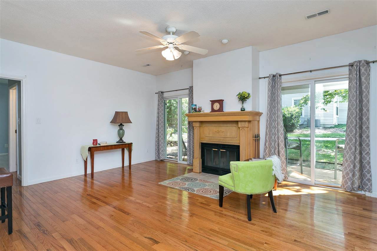 6020 Winterpointe Lane, Unit 101 Raleigh, NC 27606 - Photo 3 of 23 Living Room with hardwood floors and a wood burning fireplace Living Room