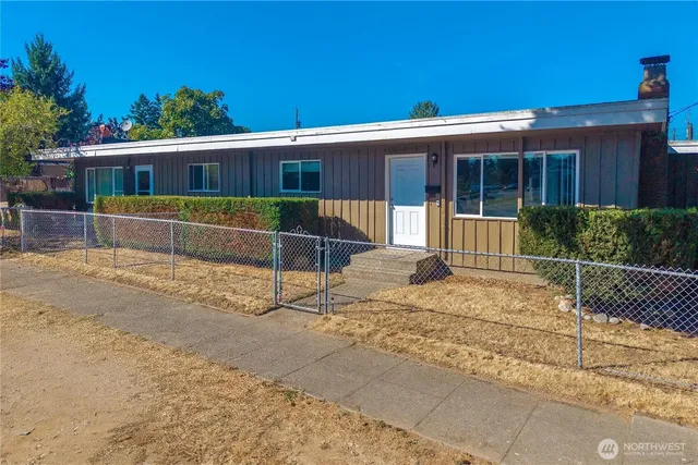 a view of a house with a wooden fence