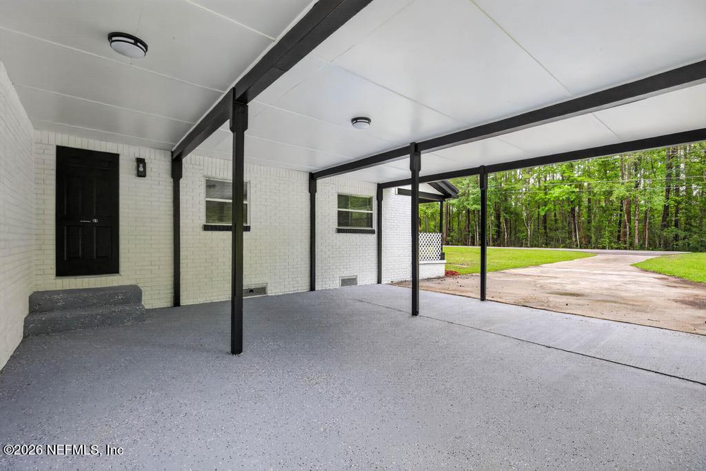 43739 Ratliff Road Callahan, FL 32011 - Photo 8 of 55 a view of an empty room with wooden floor and windows
