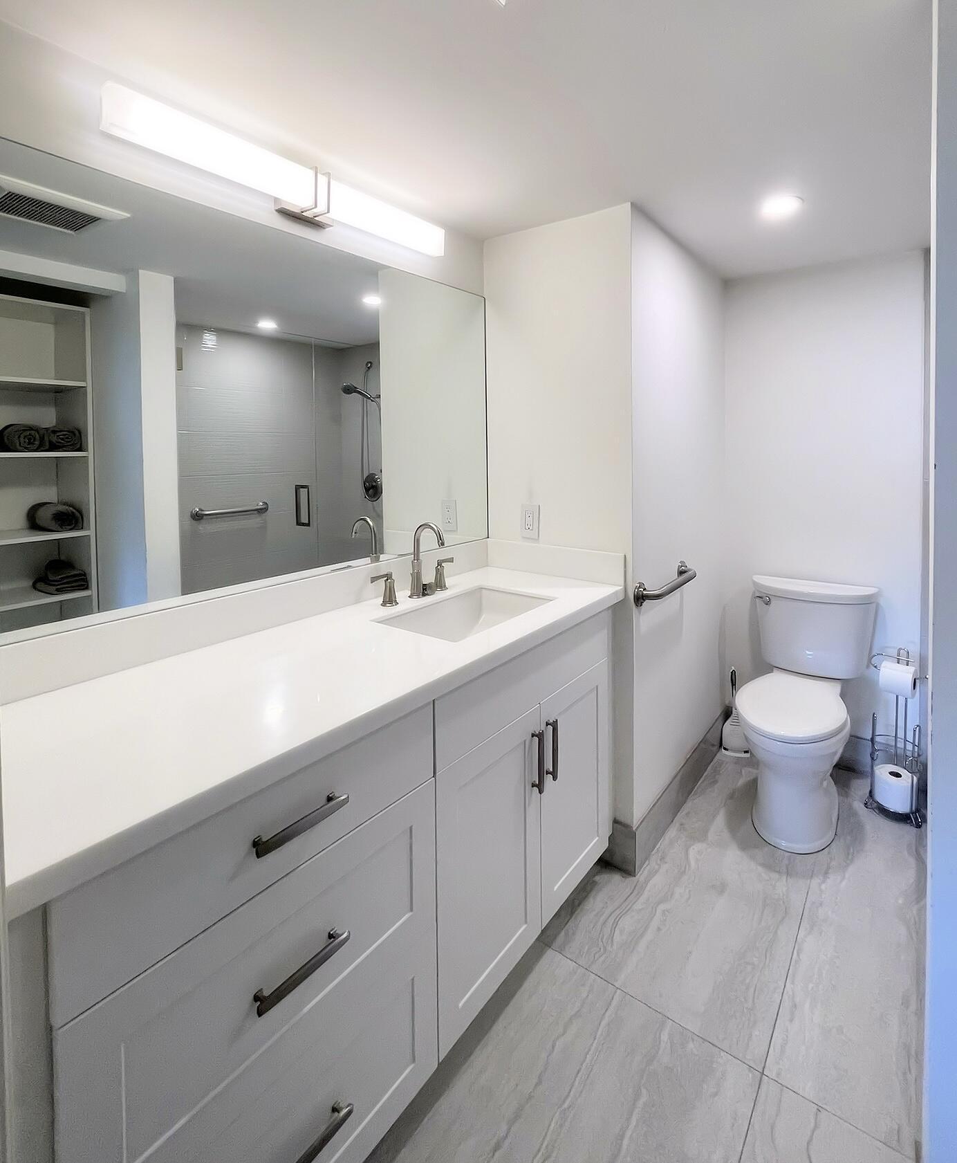 1030 Rexford B Boca Raton, FL 33434 - Photo 15 of 27 a bathroom with a double vanity sink and a mirror