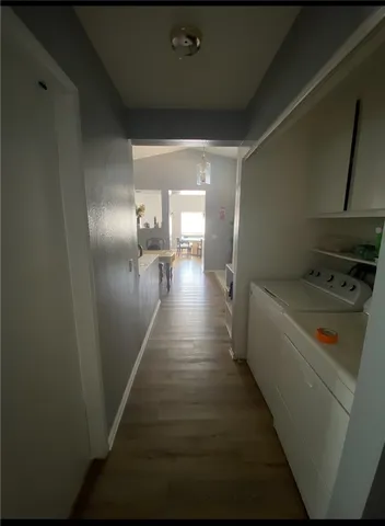 a view of a hallway with a kitchen