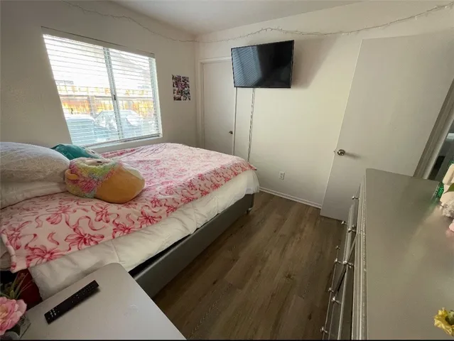 a bedroom with a bed and a flat screen tv