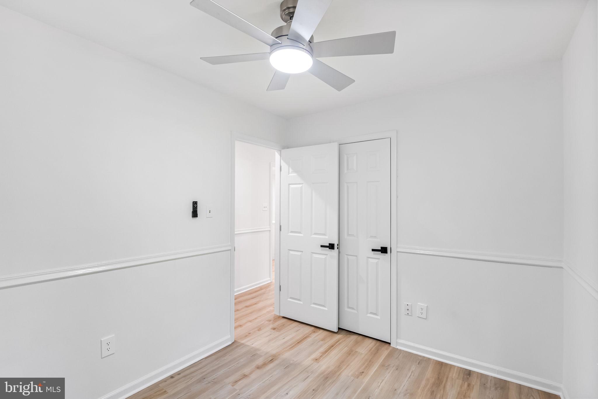 3 Boston Cove Ruther Glen, VA 22546 - Photo 26 of 30 an empty room with wooden floor fan and windows
