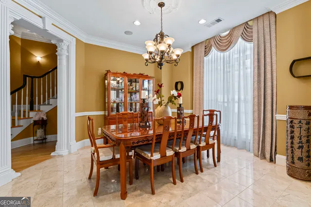 a view of a dining room and chandelier fan