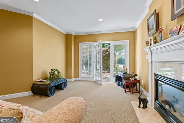 a bedroom with furniture and a large window