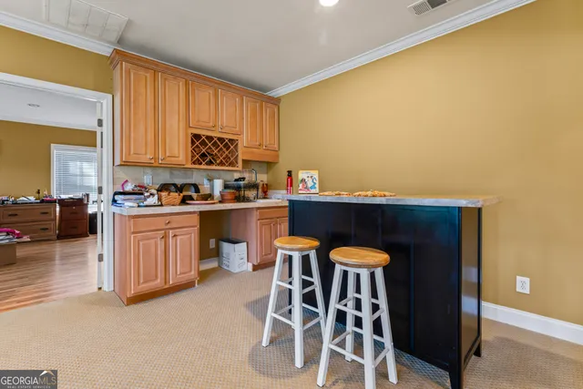 a kitchen with a sink cabinets and wooden floor