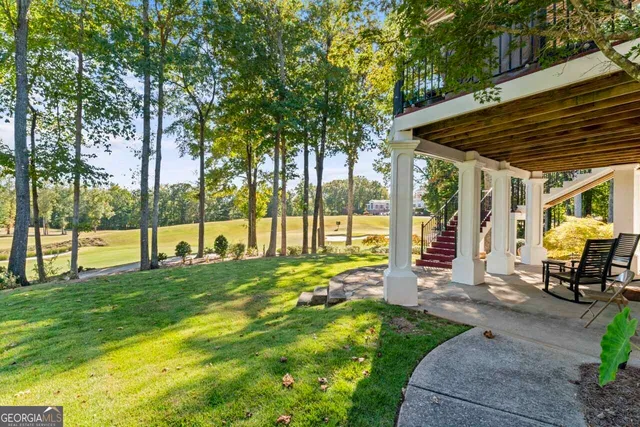 a view of a backyard with sitting area