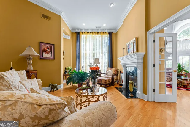a living room with furniture fireplace and a large window
