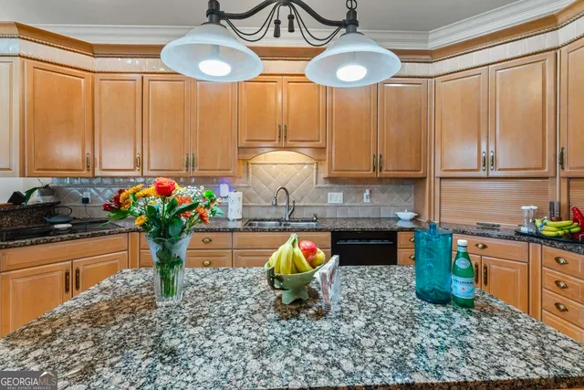 a kitchen with stainless steel appliances granite countertop a stove a sink and a refrigerator