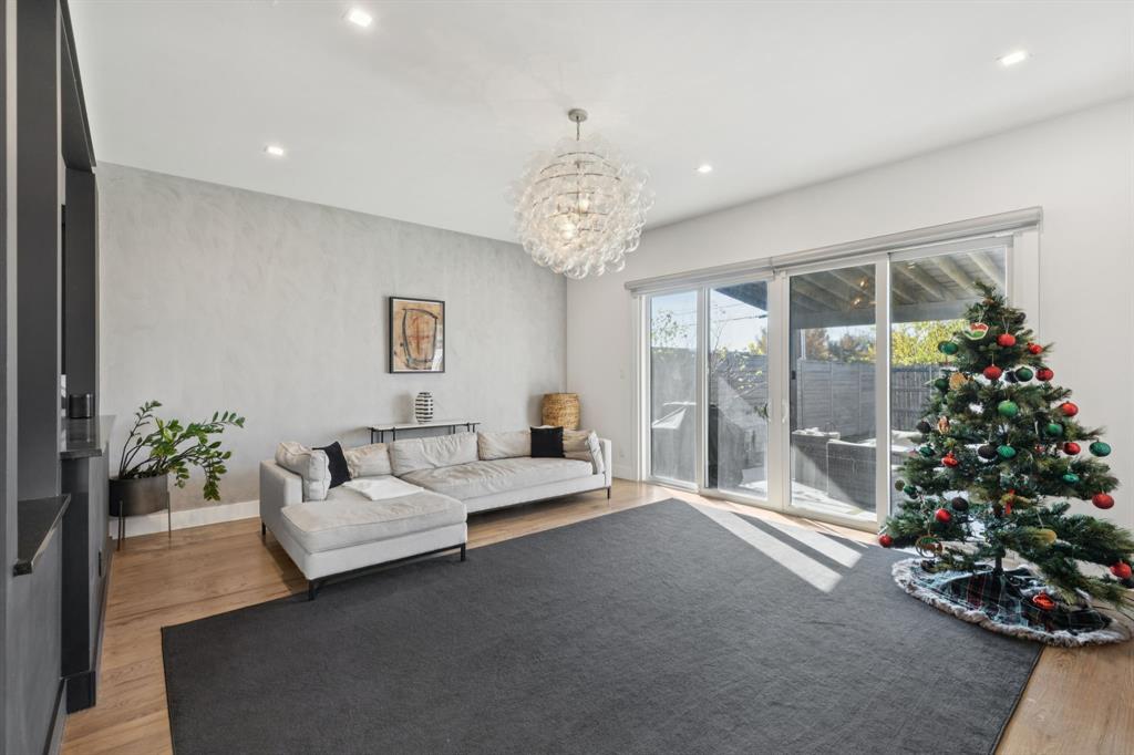 2231 Madera Street Dallas, TX 75206 - Photo 14 of 37 a living room with couch flowers and a chandelier