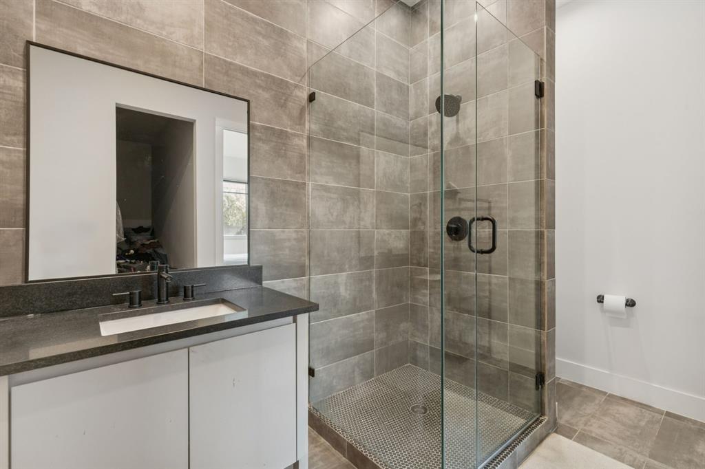 2231 Madera Street Dallas, TX 75206 - Photo 17 of 37 a bathroom with a shower sink and mirror