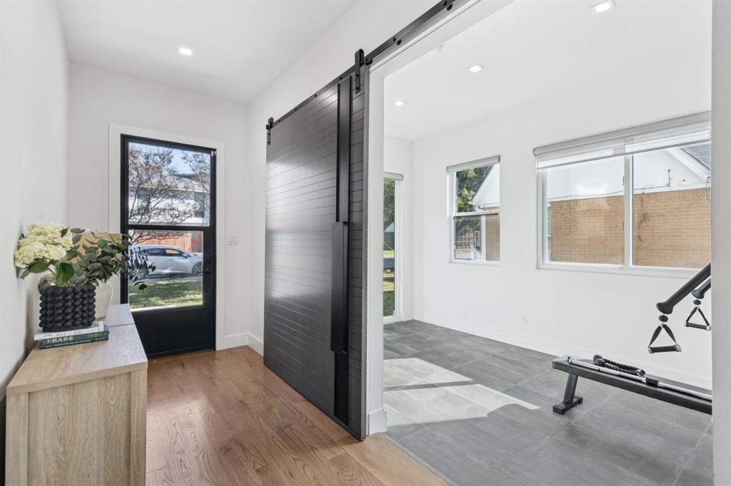 2231 Madera Street Dallas, TX 75206 - Photo 2 of 37 a view of a hallway with wooden floor and a living room
