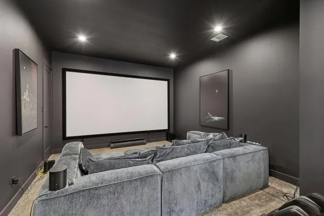 a living room with couch and a projector