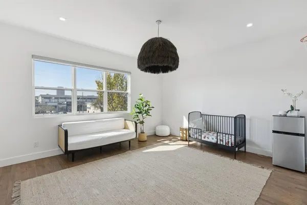 a bedroom with furniture and a window