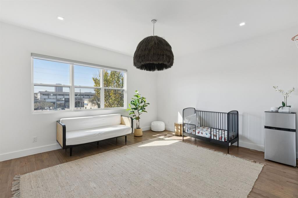 2231 Madera Street Dallas, TX 75206 - Photo 22 of 37 a bedroom with furniture and a window