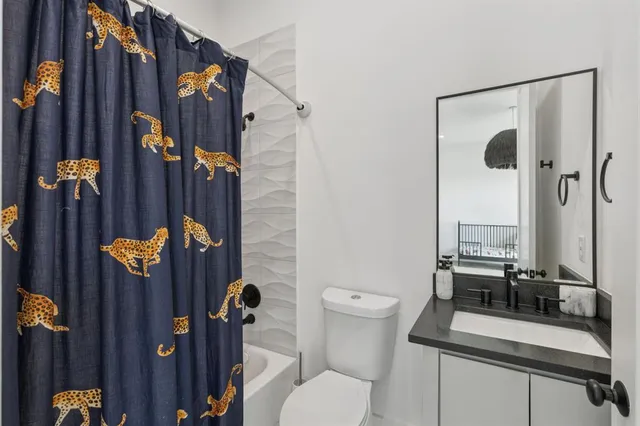 a bathroom with sink mirror and toilet