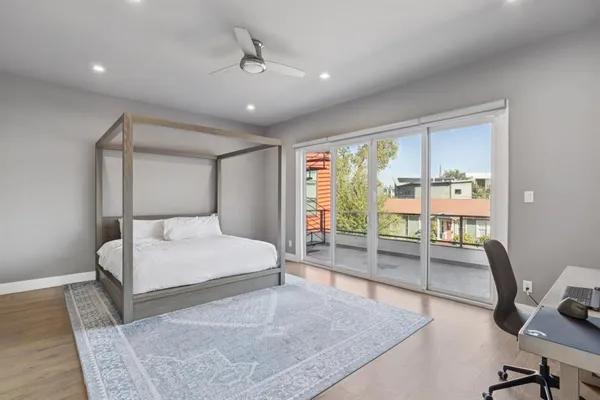 a bedroom with a bed a desk and chair