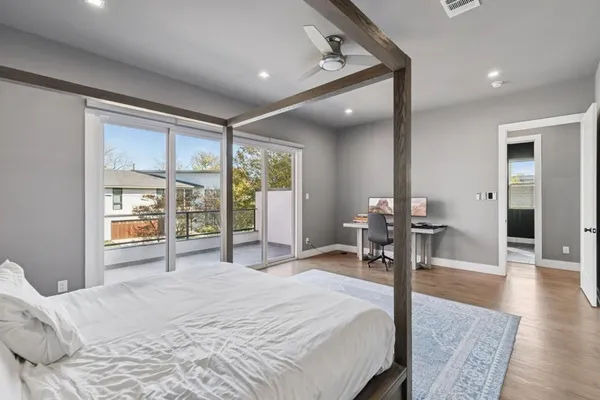 a bedroom with a bed and a large window