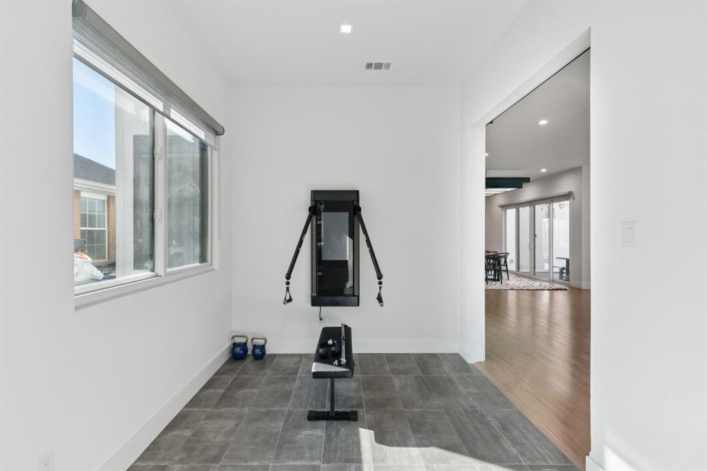 2231 Madera Street Dallas, TX 75206 - Photo 3 of 37 a picture of empty room with wooden floor and windows