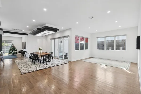 a living room with furniture window and wooden floor