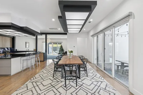 a view of a dining room with furniture window and wooden floor