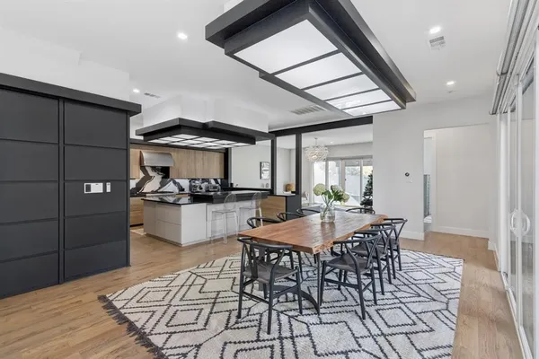 a dining room with furniture and wooden floor