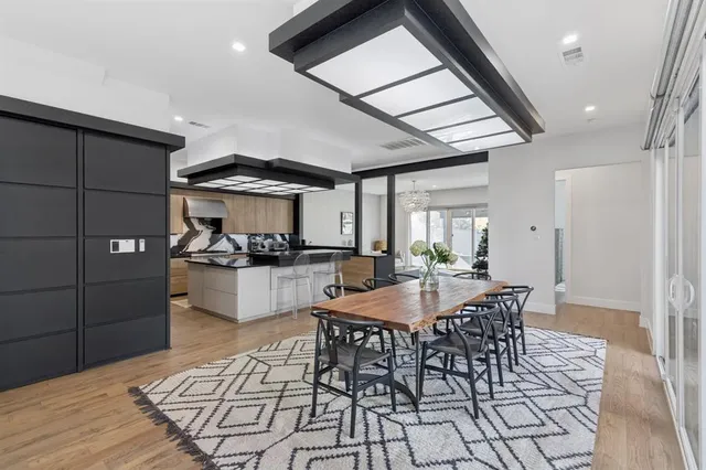 a dining room with furniture and wooden floor