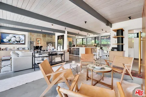a kitchen with furniture and a window