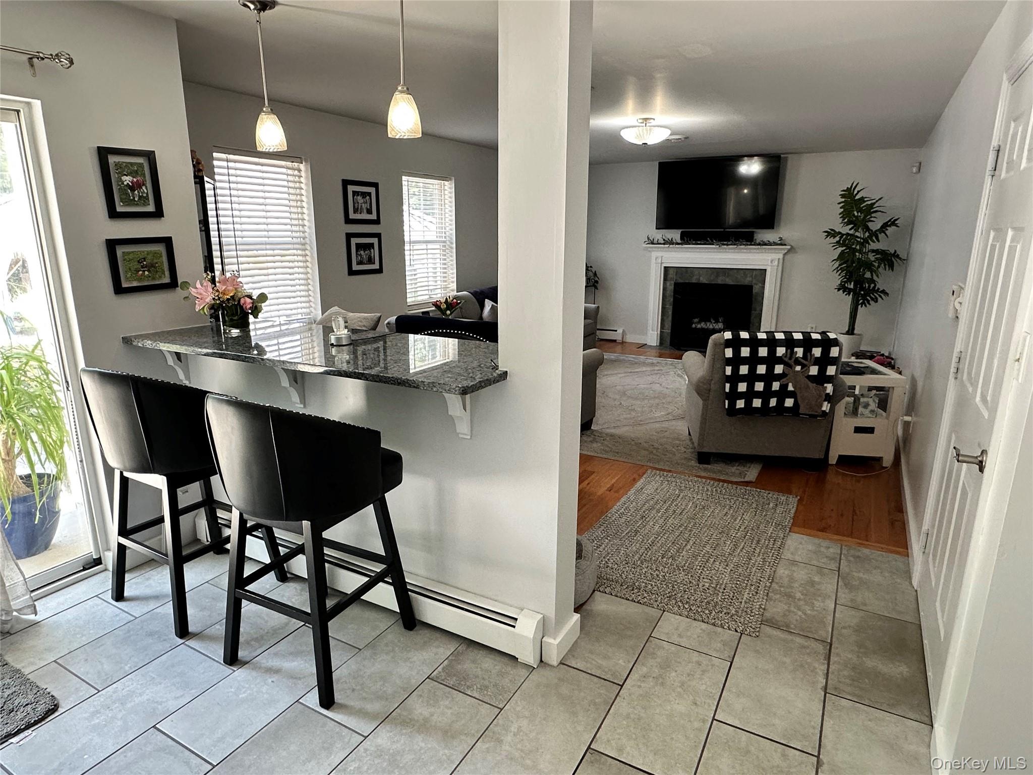 95 Weed Road Pine Bush, NY 12566 - Photo 5 of 31 Kitchen pass-through with a granite countertop and pendant lighting leading into the Living Room