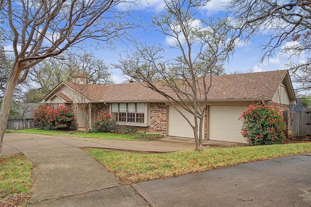 3200 Hickory Court Bedford, TX 76021 - Photo 2 of 30 Ranch-style house with roof with shingles, brick siding, a garage, and driveway