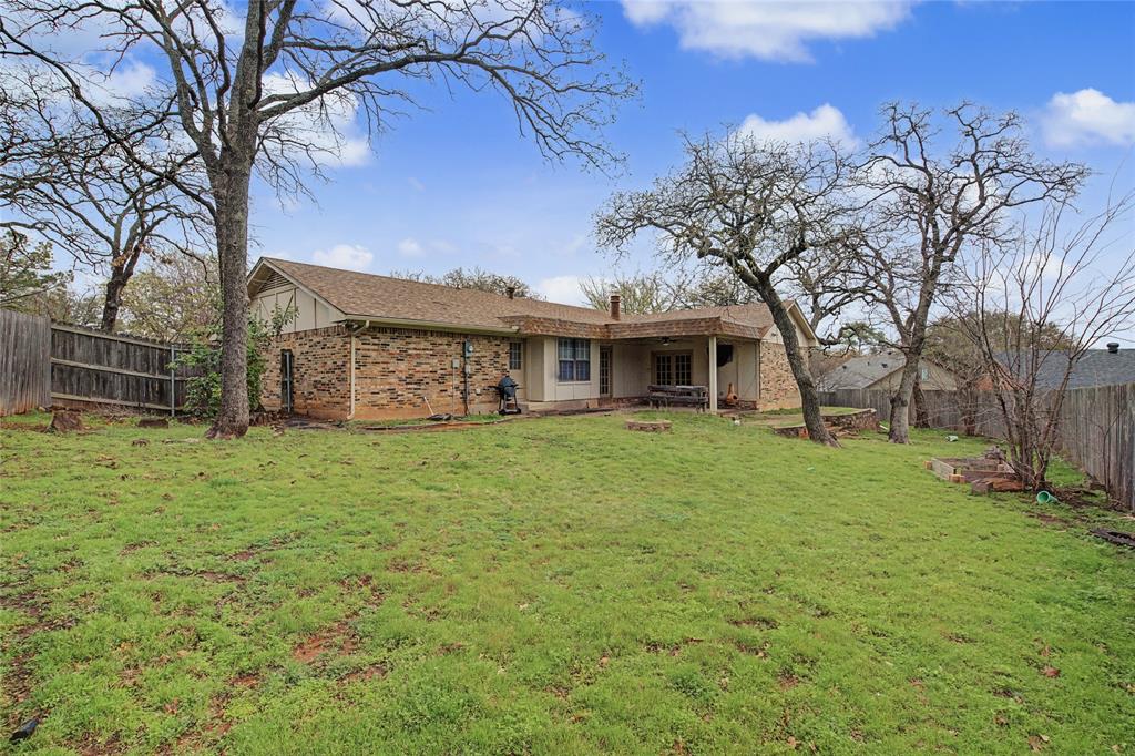 3200 Hickory Court Bedford, TX 76021 - Photo 26 of 30 Back of house with a fenced backyard, a patio, brick siding, and roof with shingles