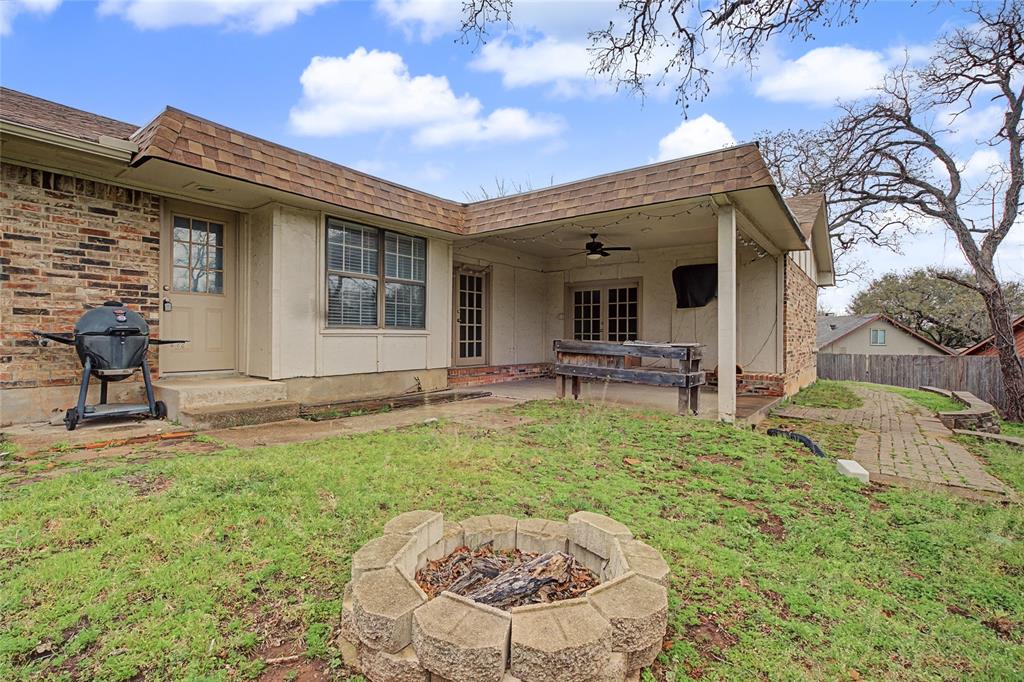 3200 Hickory Court Bedford, TX 76021 - Photo 30 of 30 Back of property with roof with shingles, ceiling fan, mansard roof, and a patio area