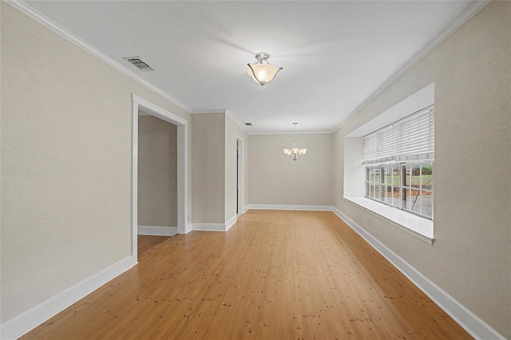 3200 Hickory Court Bedford, TX 76021 - Photo 5 of 30 Empty room with ornamental molding, light wood finished floors, and suspended lighting