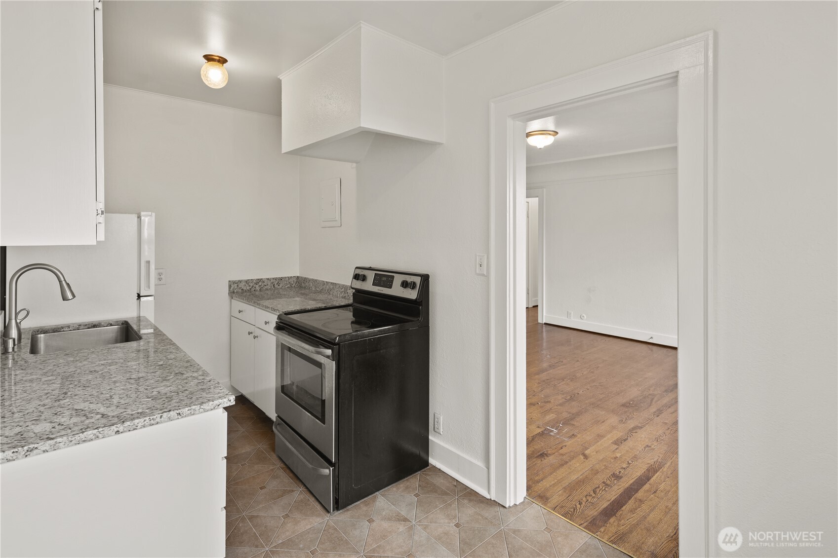 741 Federal Avenue East Seattle, WA 98102 - Photo 5 of 21 a kitchen with granite countertop a sink and a stove top oven